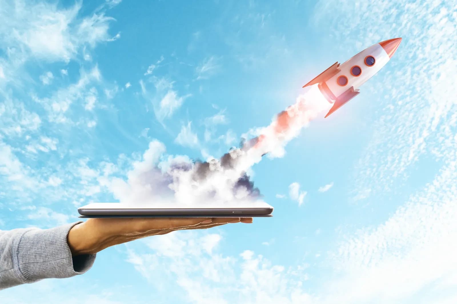 Rocket launching from a tablet, representing a product launch